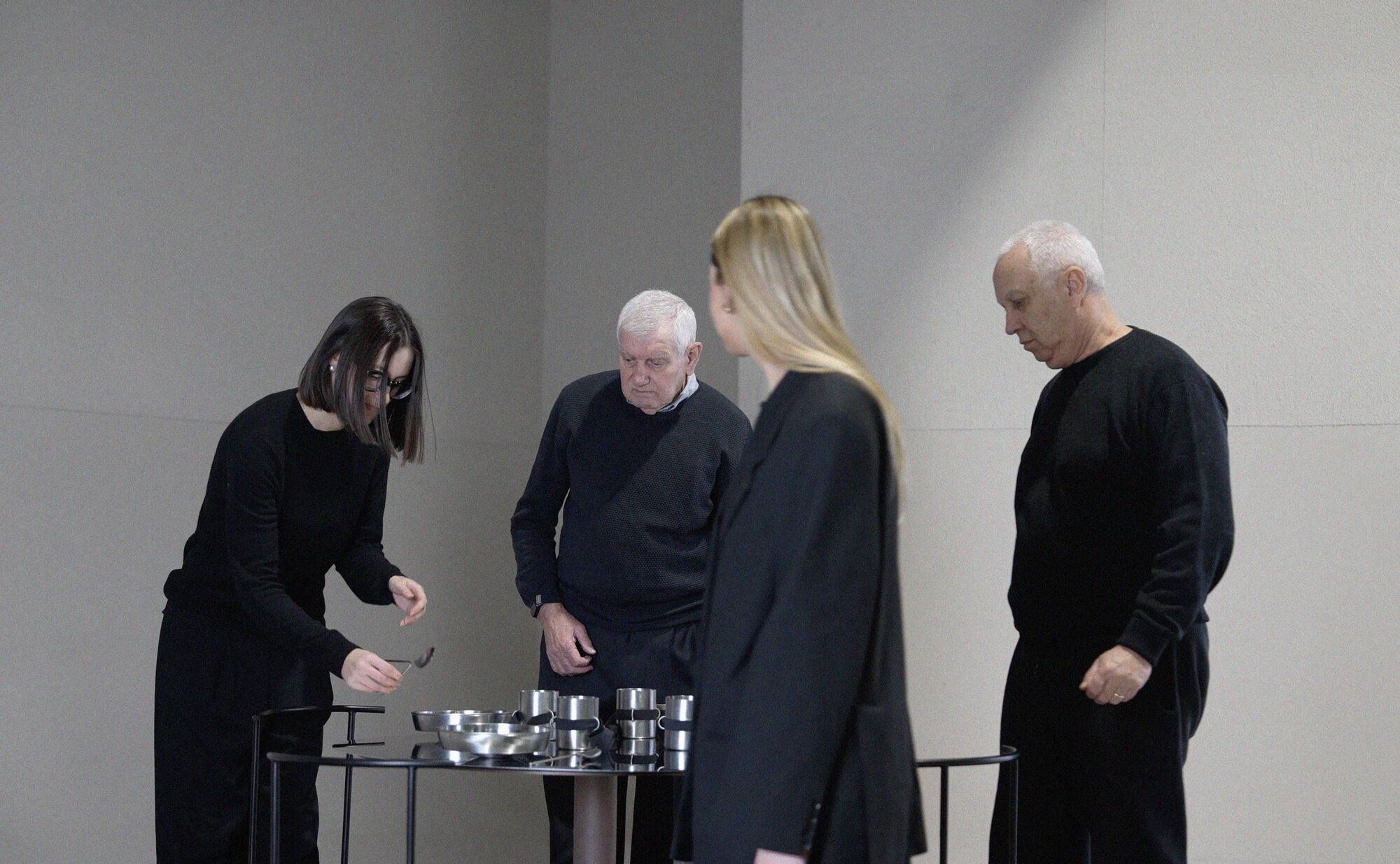 Tavola Distorta — visitors gathered around the table during the exhibition